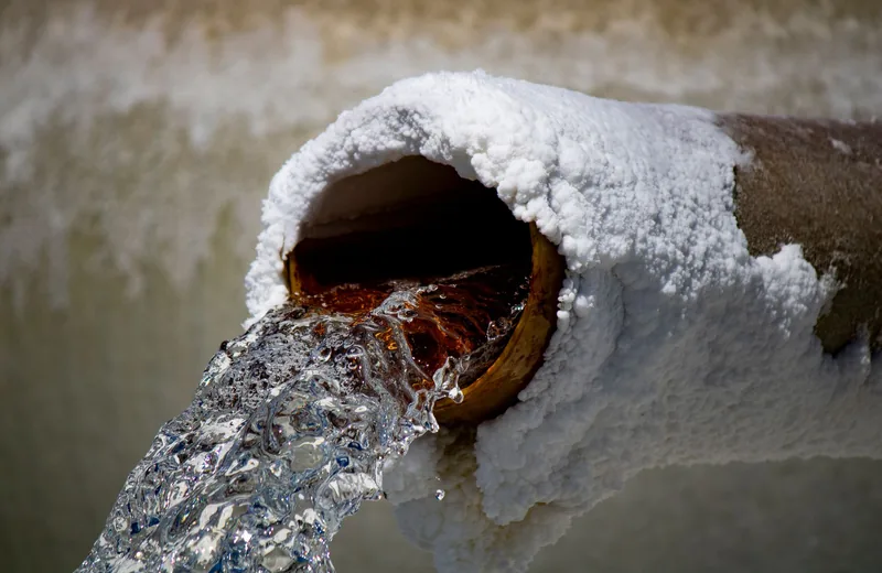 Water gushing from a burst pipe that needs emergency repair
