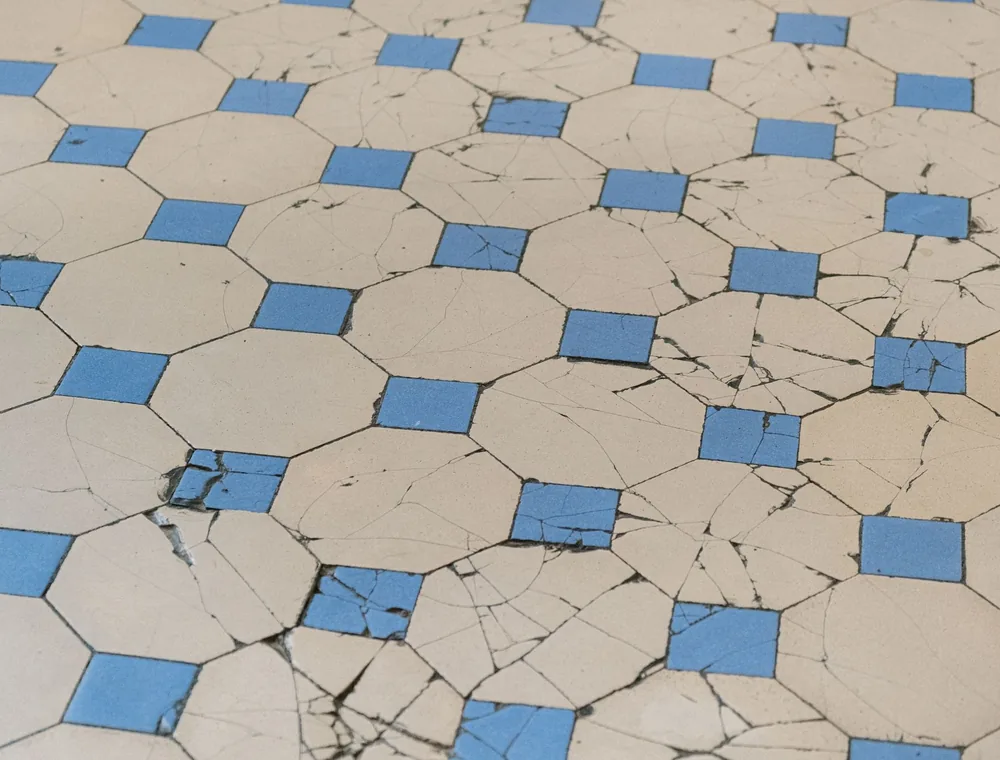 Cracked floor tiles above a slab leak under the foundation