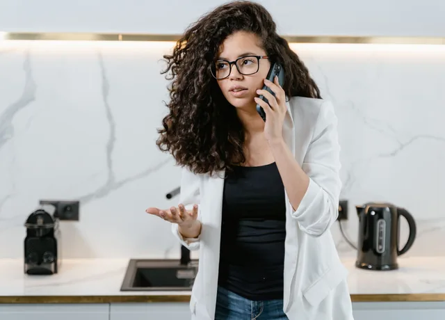 Homeowner on the phone describing a leak in her kitchen