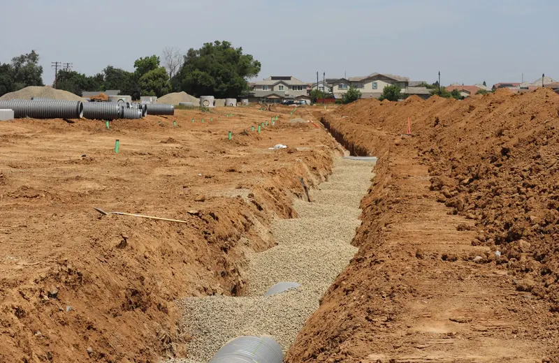 Excavated trench exposing a residential water service line for leak repair